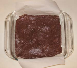 Baking pan with brownie batter, showing placement of parchment