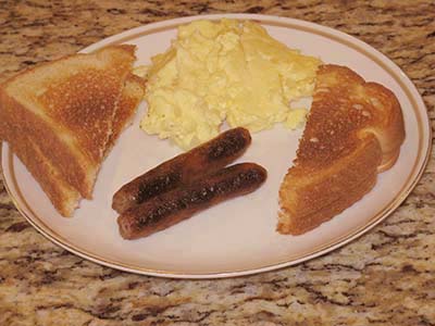 Scrambled eggs with sausage and toast